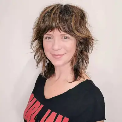 Mid-Length Shag with Choppy Layers and Bangs for 40-Year-Old Women