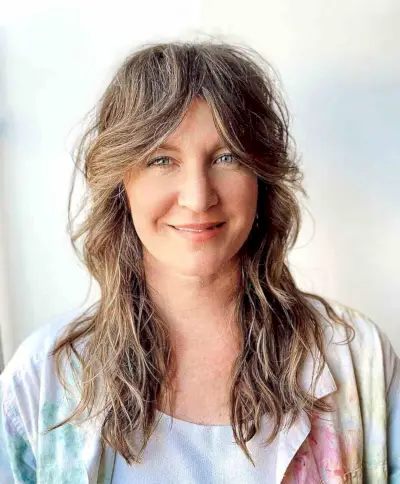 Razored Shag with Long Curtain Bangs for a 40-Year-Old Lady