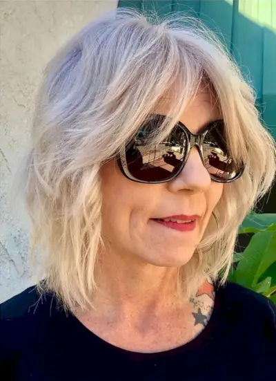 Modern wavy shag haircut for women past their 50s with fine hair