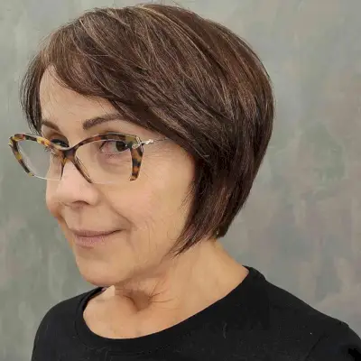 Youthful Side-Swept Bob Cut for a 60-Year-Old with Glasses