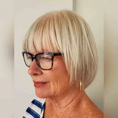 textured bob with bangs for women over 60 with glasses