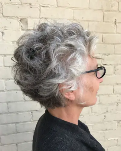 short curly hair pixie for older women wearing glasses