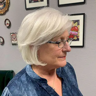 Jaw-Length Classic Short Bob with Feathered Bangs for Older Women Aged 50 with Glasses