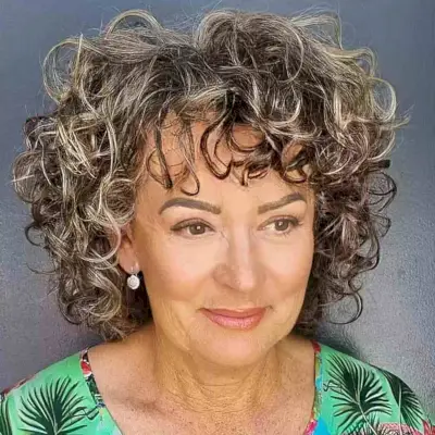 Shoulder-Length Curly Bob with Piece-y Bangs on Women Aged 50