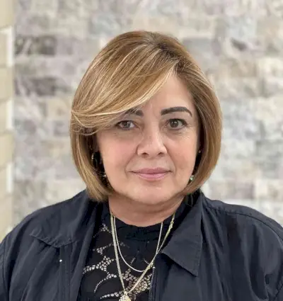 Jaw-Length Cut with Long Side-Swept Bangs and Blonde Highlights for Women Past 50