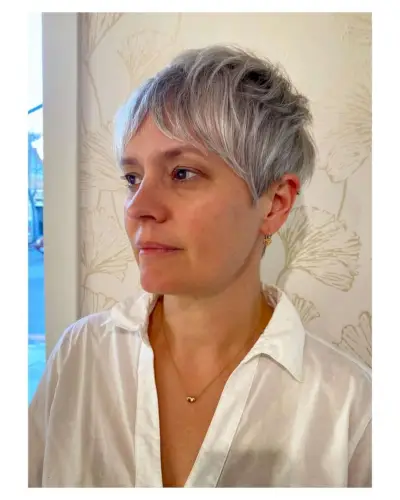 Natural-Looking Choppy gray pixie cut with long bangs for 50-year-olds