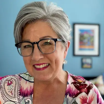 Long pixie cut on an older woman with glasses