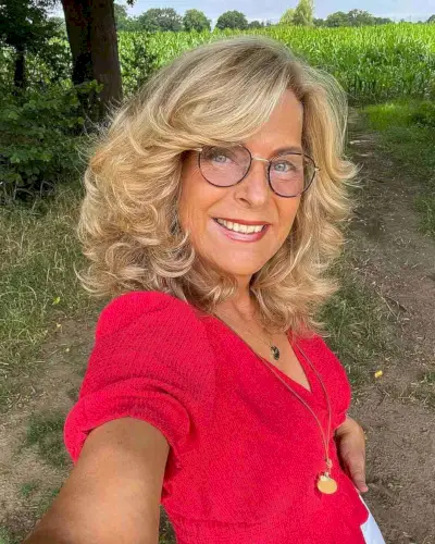 Shoulder-Length Blonde Feathered Hair with Short Layers for 50-Year-Olds