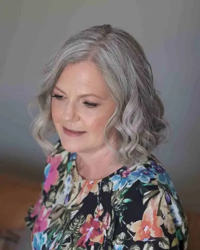 Neck-Length Cut with Soft Curls for a 50-Year-Old Lady