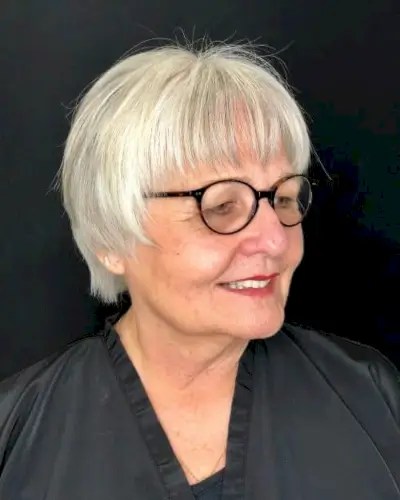 short hairstyle for over 50 with glasses and a round face