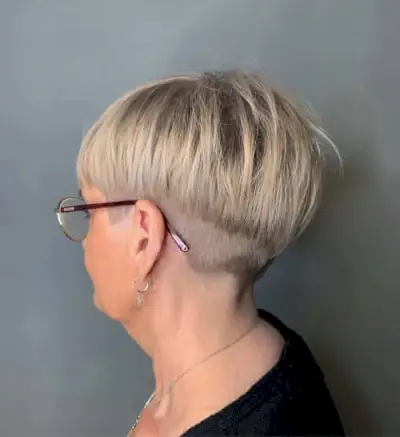 Youthful short cut for woman in her 50s and wearing glasses