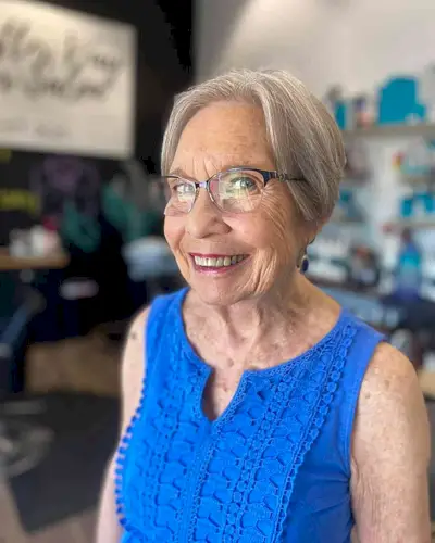 Face-Framing Silver Pixie for Seniors Over 60 with a pair of glasses