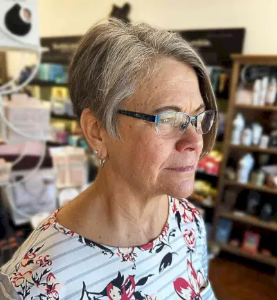Very Short Asymmetrical Haircut for women aged 60 with reading glasses