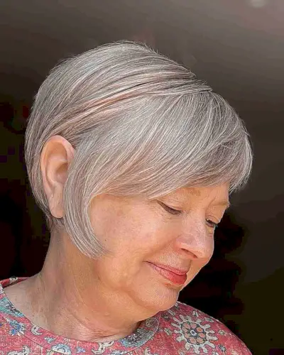 Inverted Pixie Bob with Side-Swept Bangs for a Lady in Her 50s