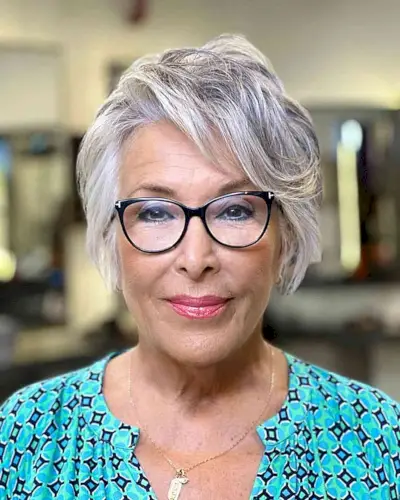 Short Feathered Gray Hairstyle with Swept Bangs for 60-year-olds