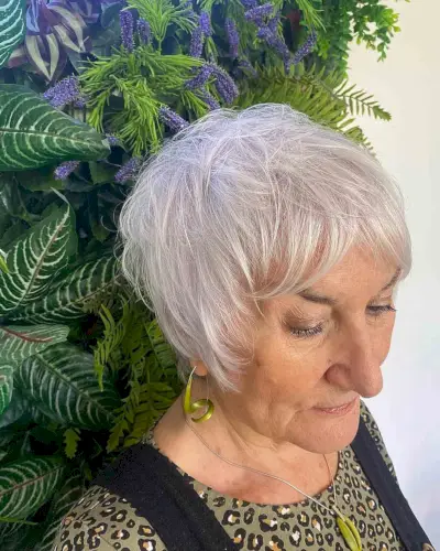 Messy Ear-Length Hair with Curtain Bangs for 70-Year-Old Women
