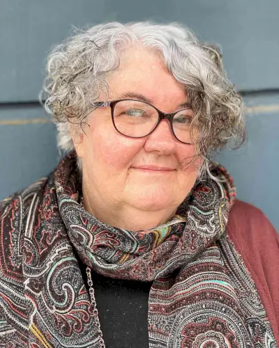 Asymmetrical Curly Haircut for Round Faces for 60-Year-Olds