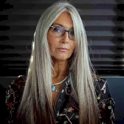 Sleek Long Hair with Long Bangs and Face Frame for Ladies Over 50 Wearing Glasses
