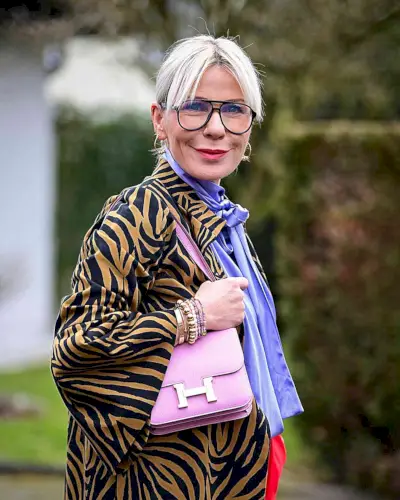 Middle Part with Eyebrow-Skimming Curtain Fringe on blonde haired women over fifty with glasses