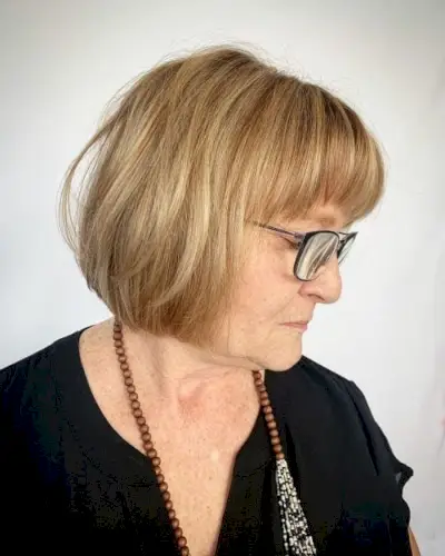 Youthful Long Bob hairstyle for older women over fifty with glasses and a round face