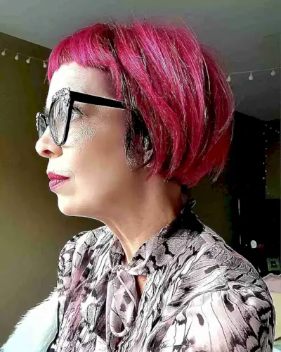 Edgy Short French Bob with Bright Pink Highlights and Short Bangs for 50-Year-Olds with Glasses