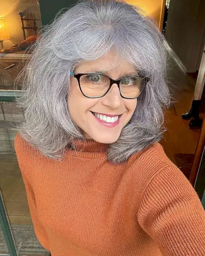 Shoulder-Length Cut with Feathered Layers and Bangs on 50-Year-Old Women with Glasses