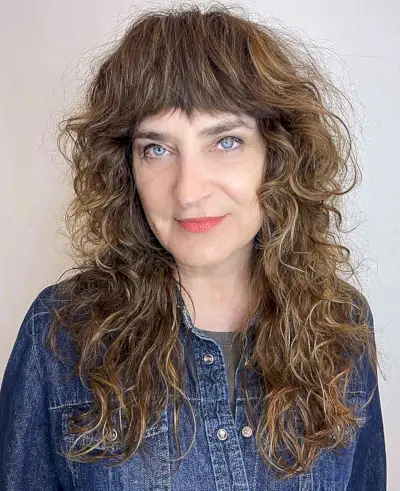 Long-Length Shagged Curly Hair with Textured Bangs on women 50 and up
