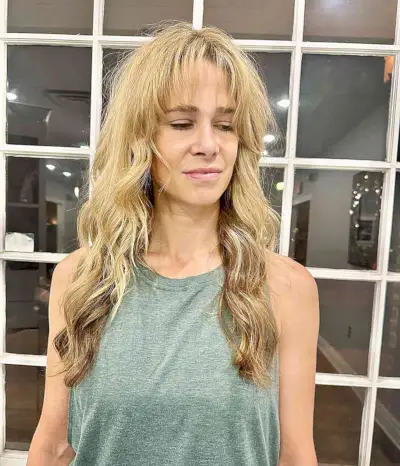 Long Blonde Waves and Barely-There Bangs for Women Over 50