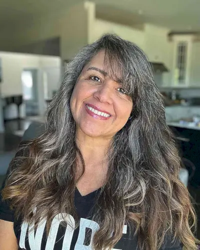 Lengthy Side-Swept Wavy Hair with Fringe for ladies passed their 50s