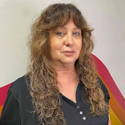 Feathered Bangs on Long Bronde Curly Shag for Women Aged 50