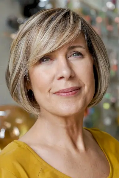 Sweeping Fringe on a Light Brown Bob for Ladies Aged 60