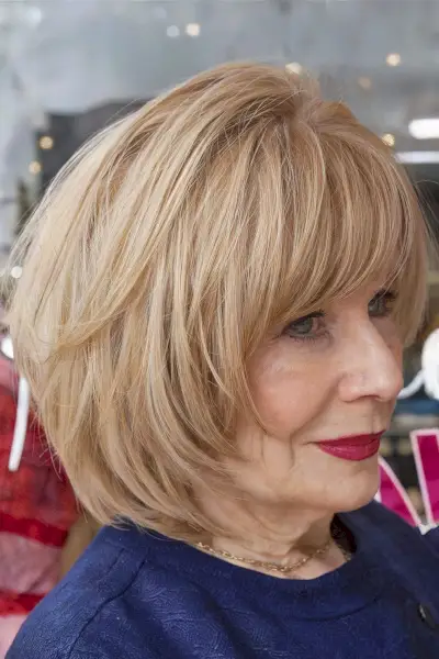 Face-Framing Bob Cut with Bangs for Ladies Over 60 with a light brown balayage