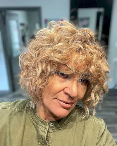 Jaw-Length Voluminous Layered Bob with Bangs and Curls of Senior Women with Blonde Hair