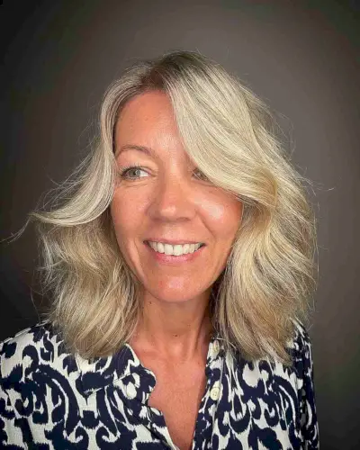 Voluminous Wavy Shoulder-Length Hair for a Lady Over Forty