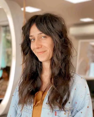 Long Messy Shag with Middle Part Bangs for a Lady in Her 40s