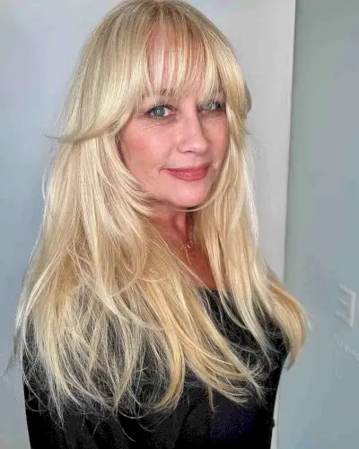 Sleek Long Blonde Hair with Wispy Bangs for Ladies 50 and Up