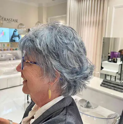 Sassy Short Hair with Feathered Choppy Layers and Balayage for Seniors Over 60 with Glasses