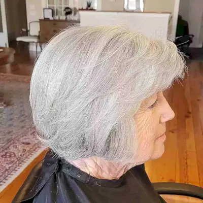 Jaw-Length Feathery Layered Bob with Side-Swept Bangs for women over 60