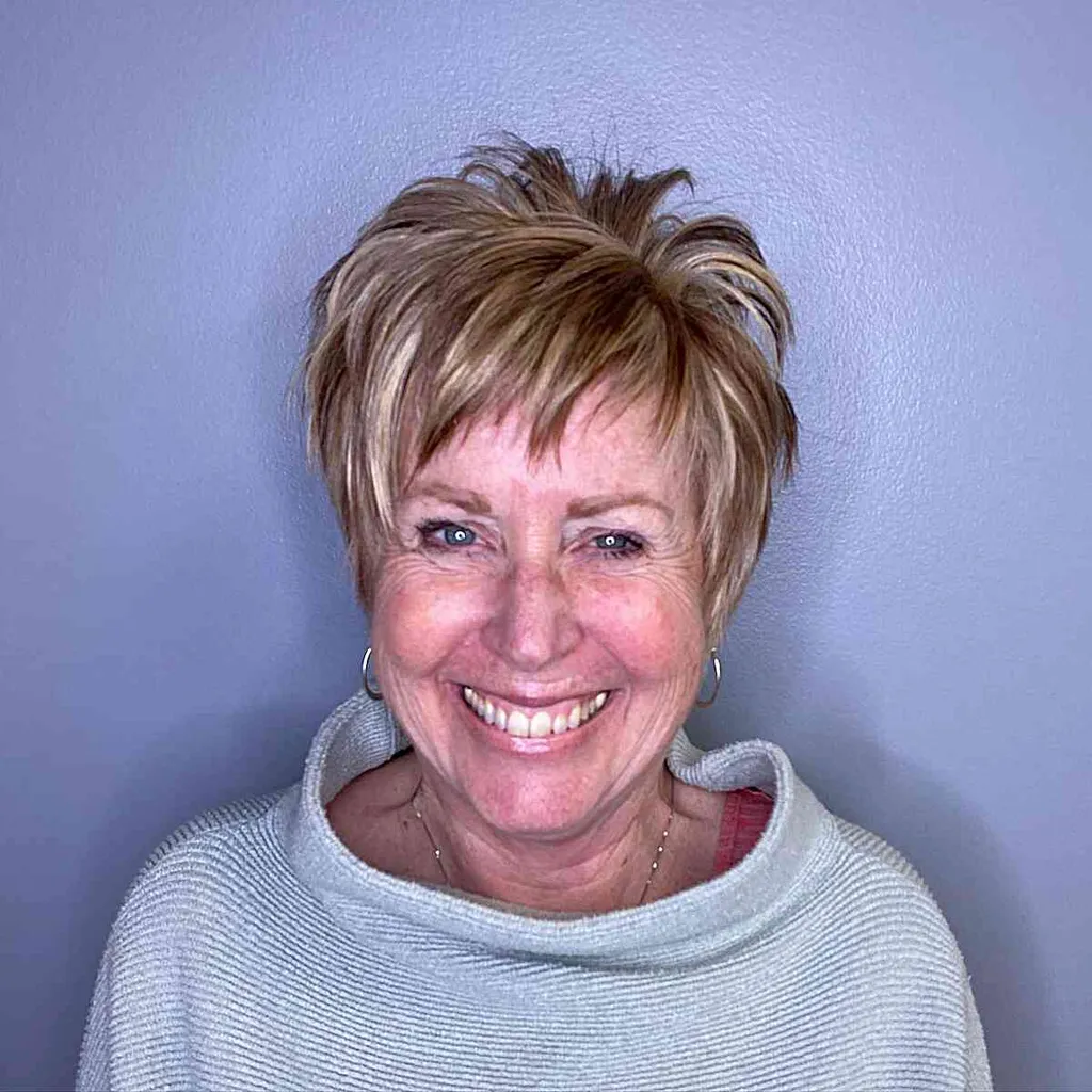 Edgy gevederde pixiesnit met schokkerige pony voor vrouwen van 60 jaar en ouder' title=