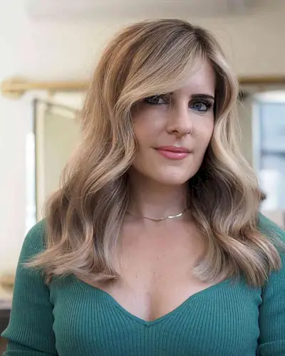 Mid-Length Dirty Blonde Balayage with a Side Part for Women Aged 40