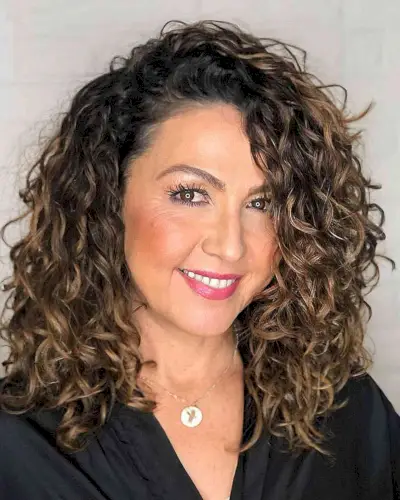 Thick Shoulder-Length Curls with Highlights for Women Aged 40