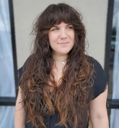 Long Tousled Curls with Bangs for a Woman Over 40 with Fine Hair