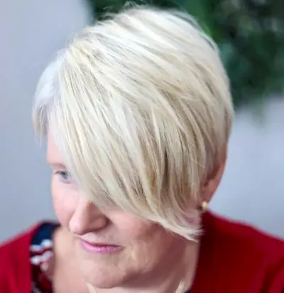 Short cut with long side swept bangs for older women