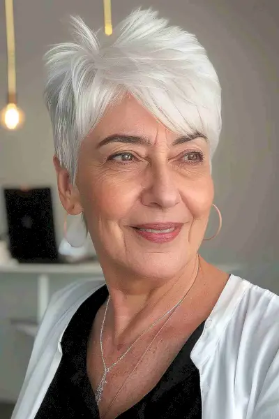 Super short crop pixie hairstyle for older women with white hair