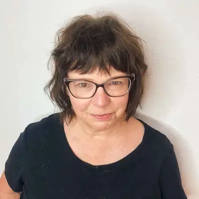 Chin-length shaggy cut with glasses