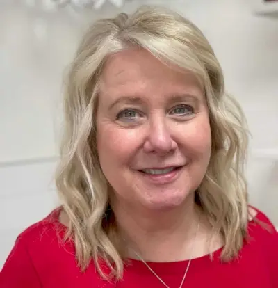 Mid-length layered bob for women in their 50s with a round face shape