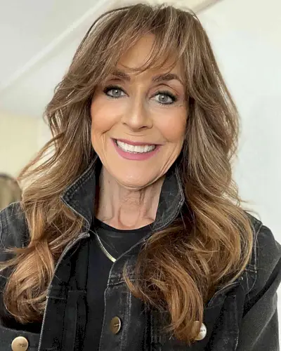 Long Brunette Waves with Wispy Feathered Bangs for Women Over 60 with Thick Hair
