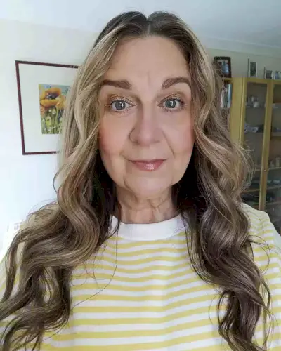 Center-Parted Wavy Long Hair with Money Piece for Ladies Aged 60 with Long Face Shapes