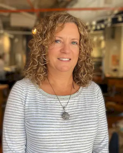 Side-Parted Curly Cut for Older Overweight Women Over 50 with Medium Hair