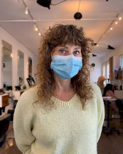 Medium Curly Hairstyle with Shagged Layers for 60-Year-Old Ladies